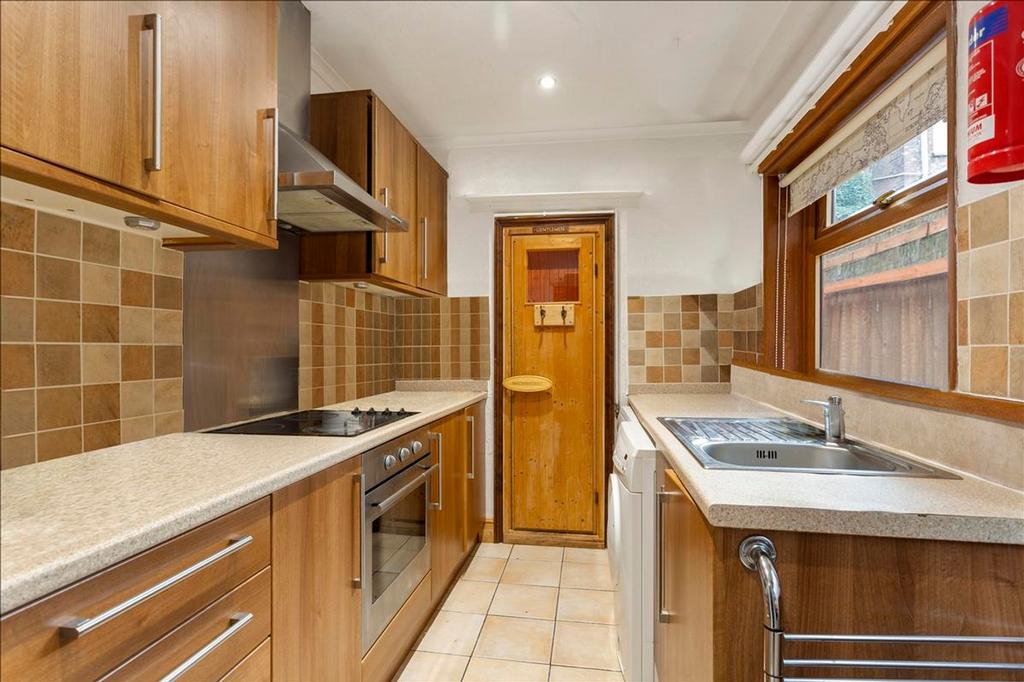 A well-equipped kitchen featuring modern wooden...