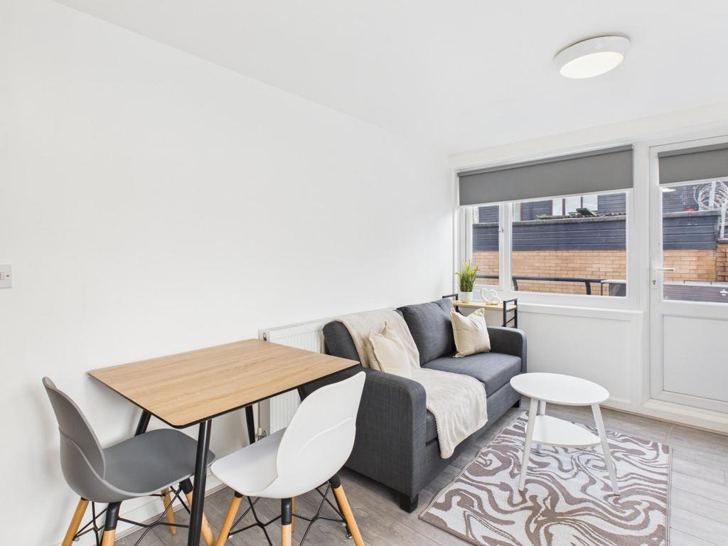 Bright, modern living area with a comfy grey so...