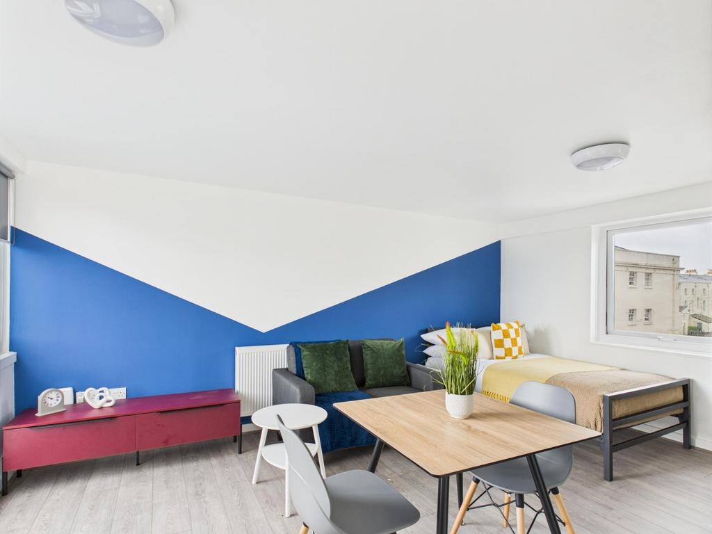 Bright, modern living room with bold geometric ...