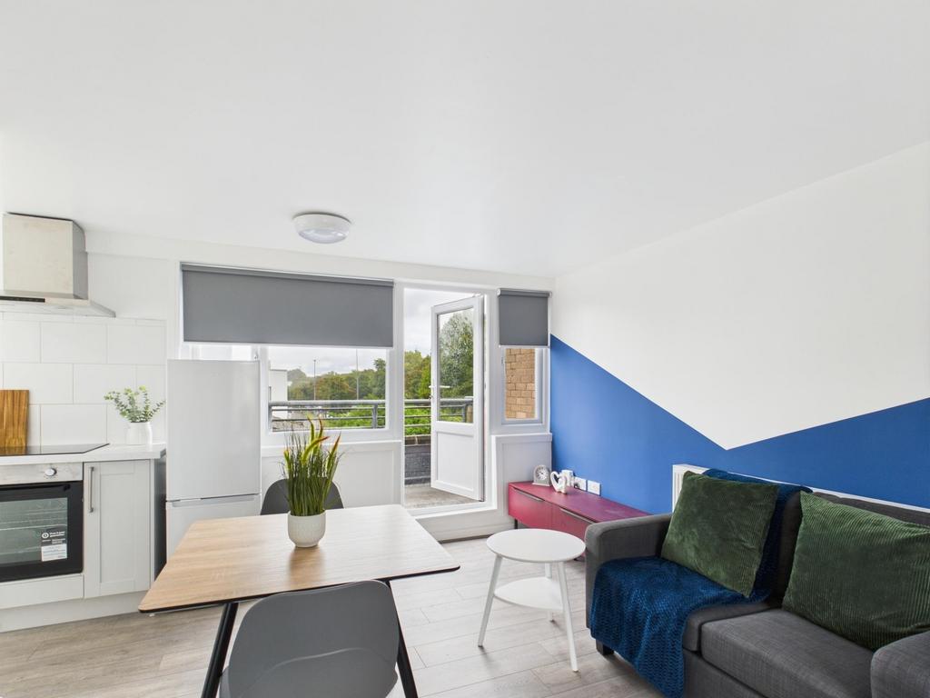 Bright open-plan living area with a compact kit...