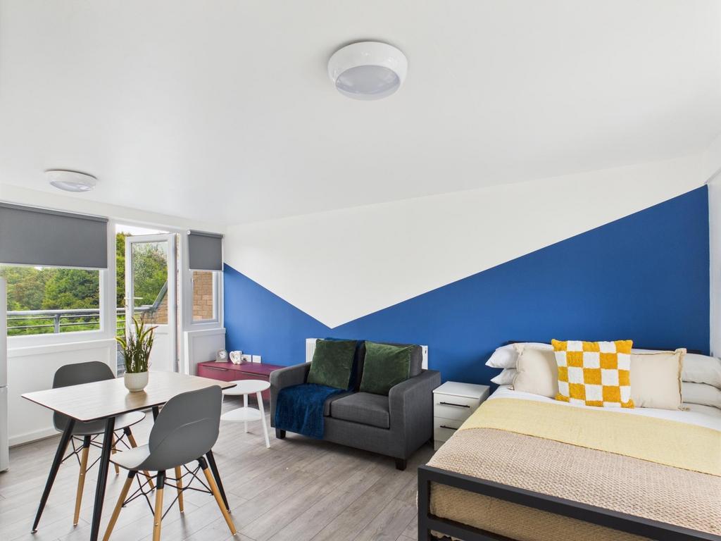 Bright, modern double bedroom with a comfortabl...