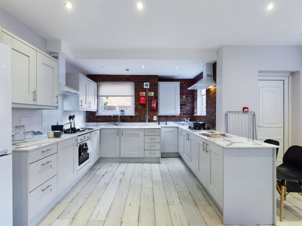 Bright and spacious kitchen with modern white c...