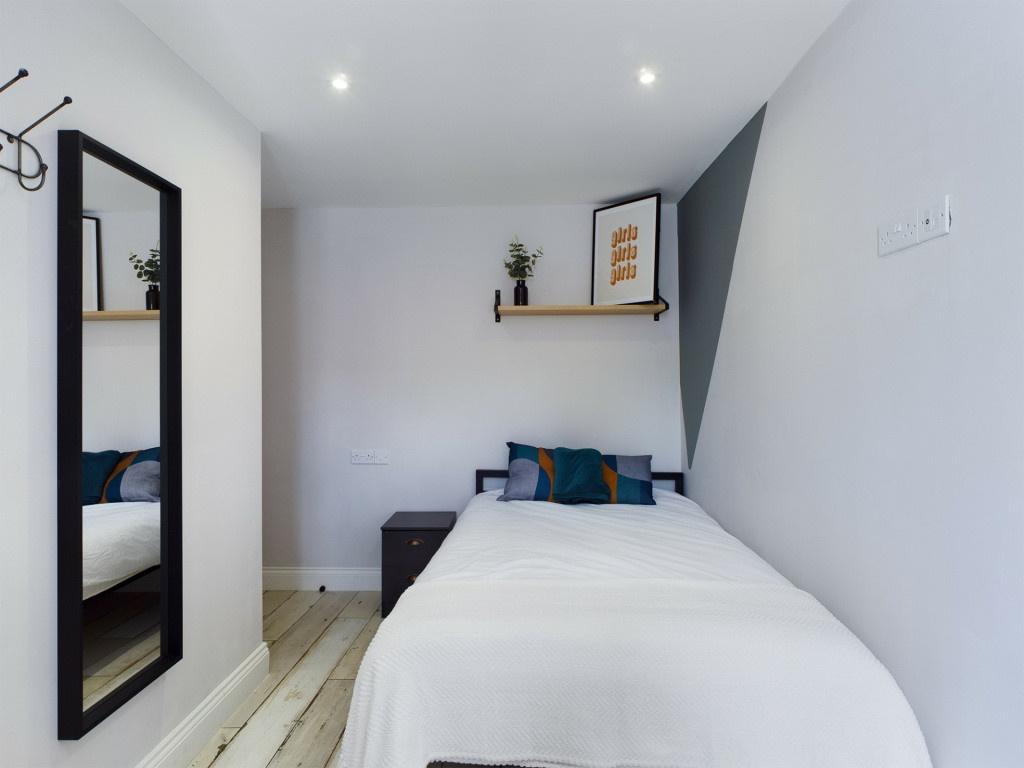 A bright and inviting single bedroom featuring ...