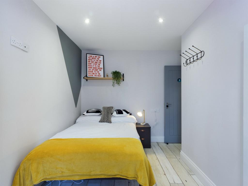 A bright and well-maintained bedroom featuring ...