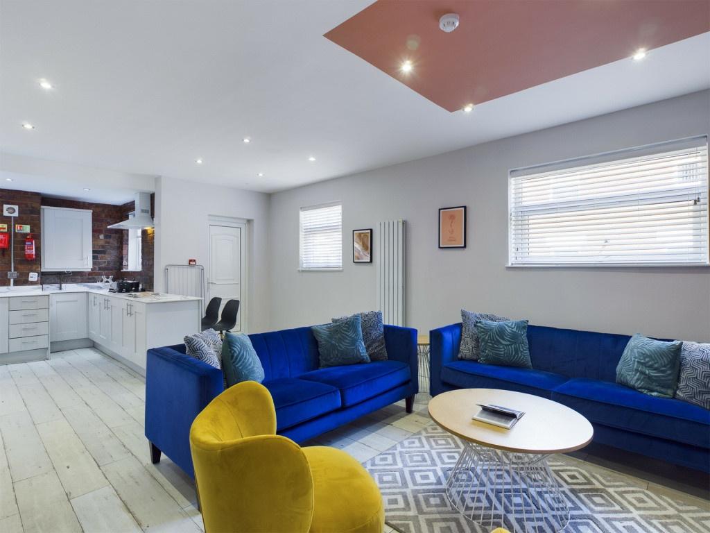 A modern and spacious living room with comforta...