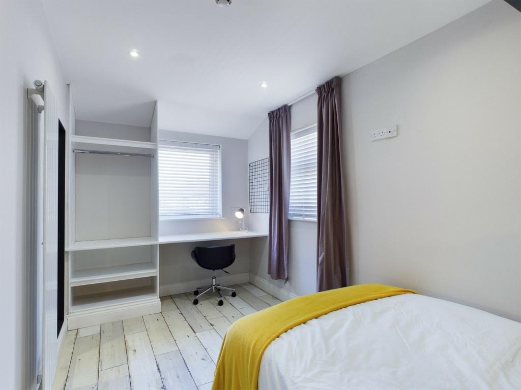 Bright and tidy bedroom with a comfortable bed,...