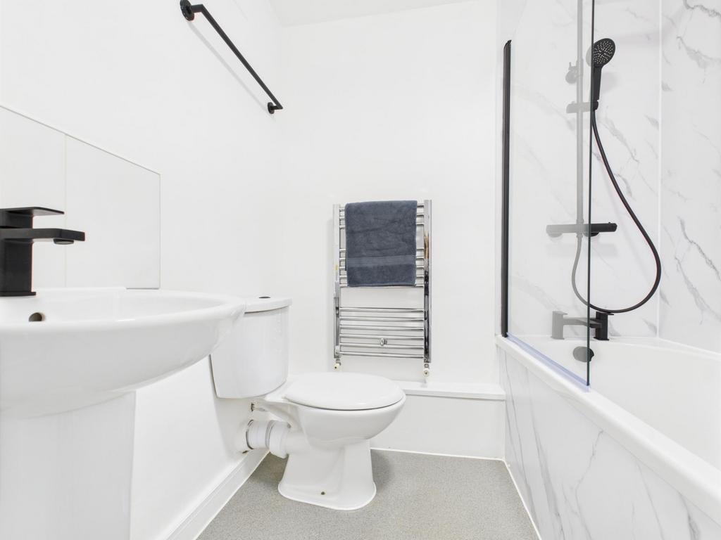 Bright, modern bathroom with white sanitaryware...