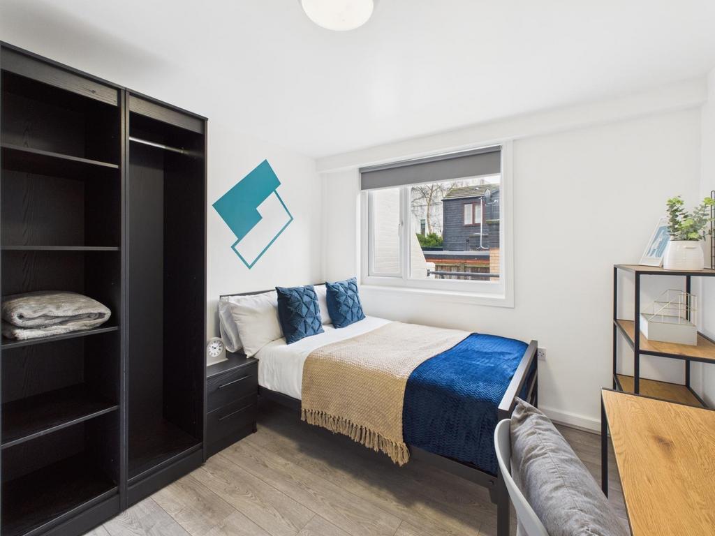 Bright, neatly presented bedroom with a comfort...