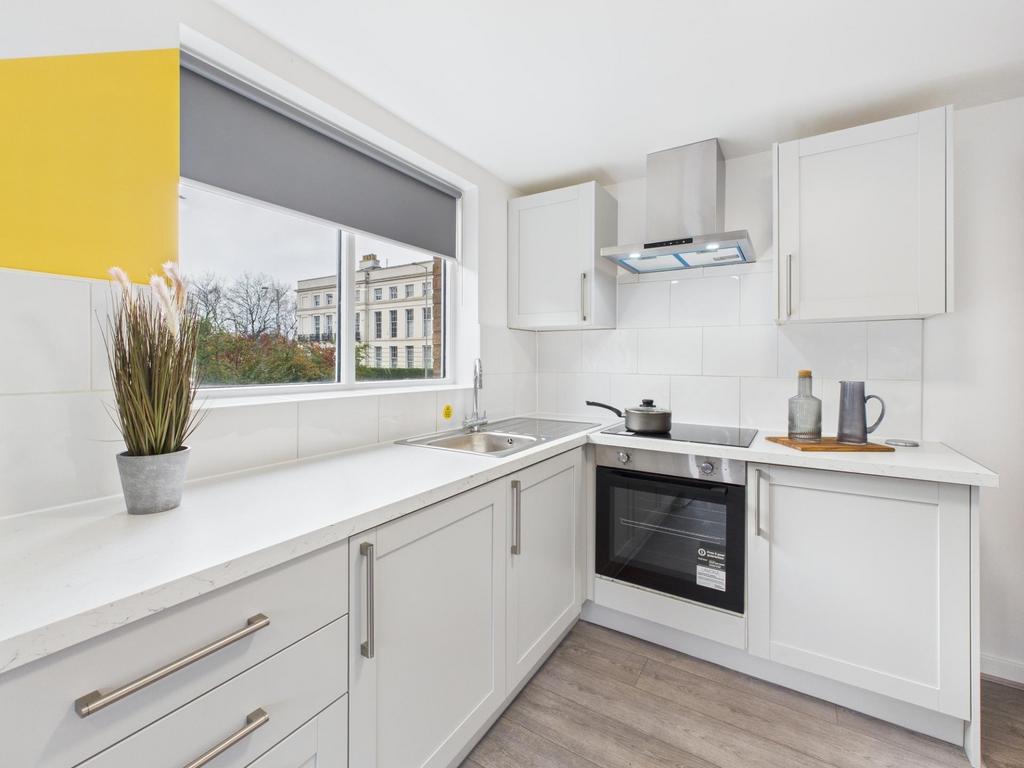 Bright modern kitchen with white shaker cabinet...