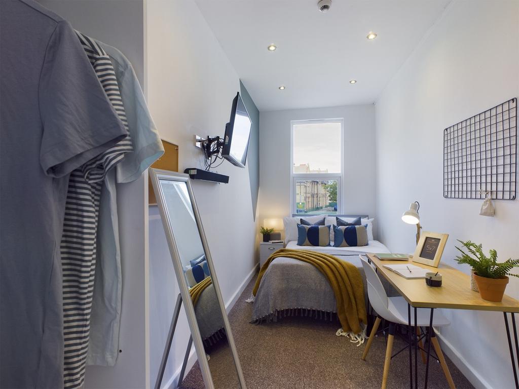 A bright and stylish double bedroom featuring a...