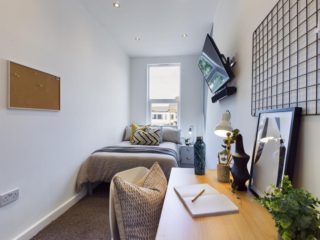 A bright and stylish double bedroom with a cozy...