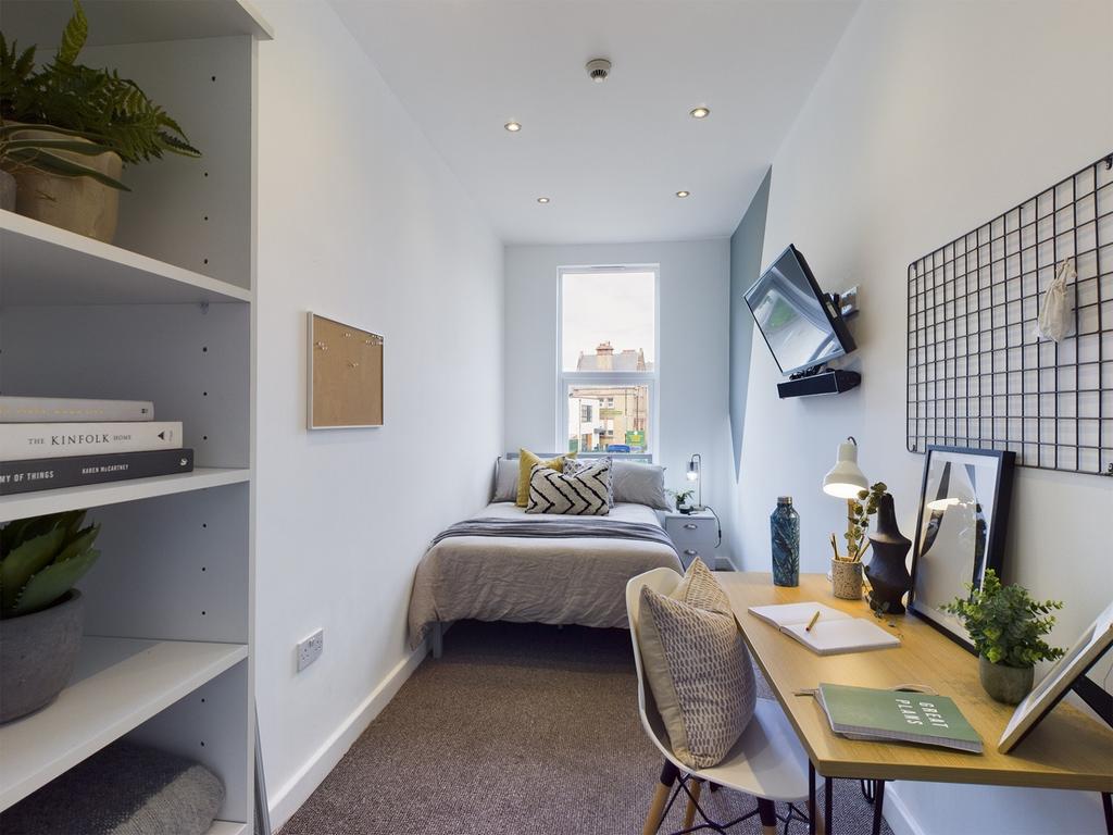 A bright and stylish double bedroom featuring a...