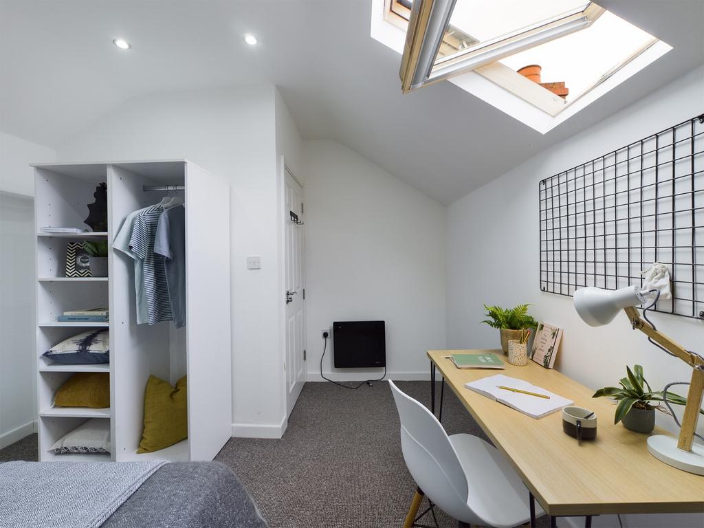 A bright and modern double bedroom featuring a ...