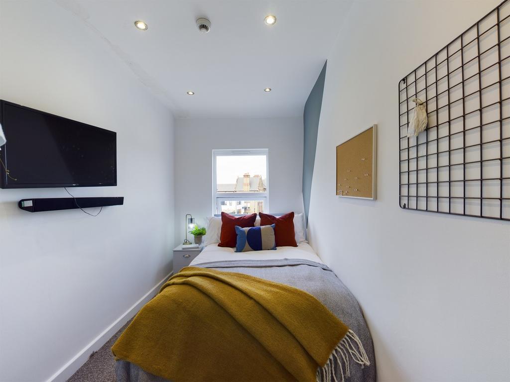 A cozy and inviting single bedroom with modern ...