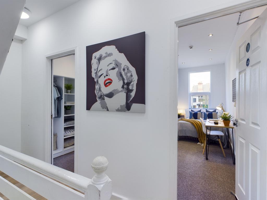 A clean and stylish hallway featuring vibrant a...