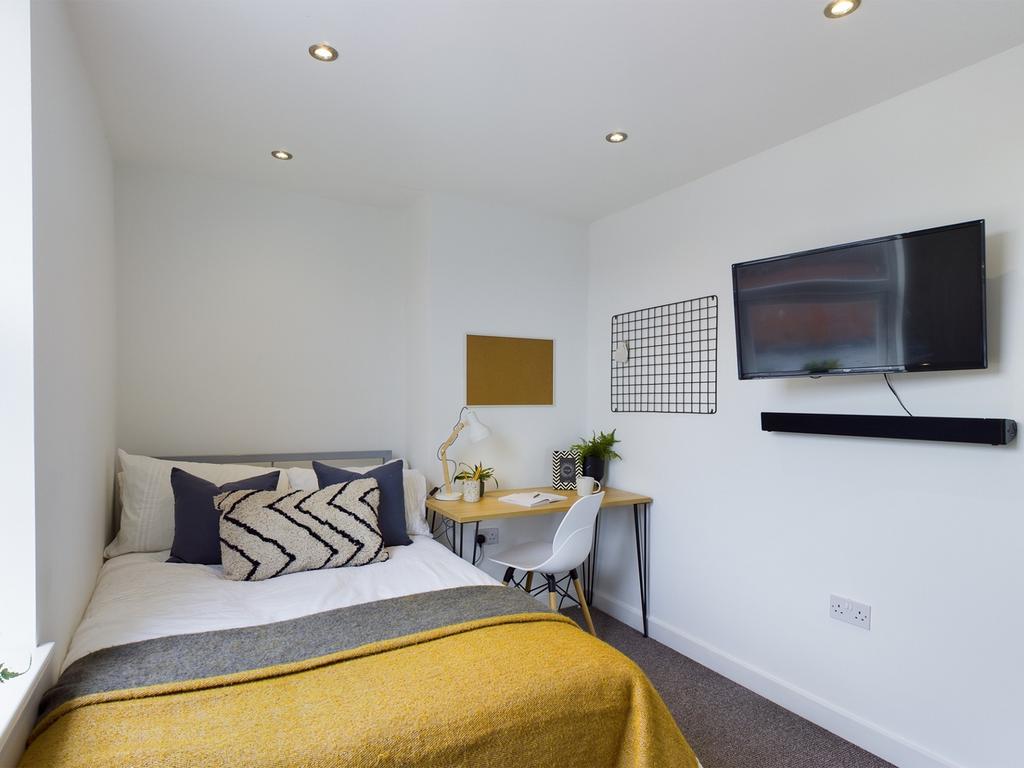 A bright and inviting double bedroom featuring ...