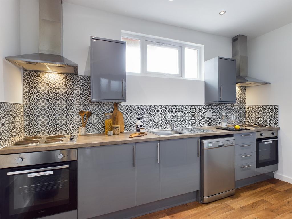 A stylish and modern kitchen featuring sleek ap...