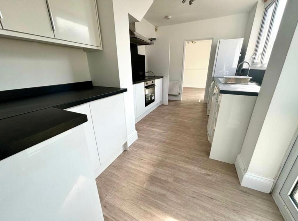 A modern and spacious kitchen with plenty of na...