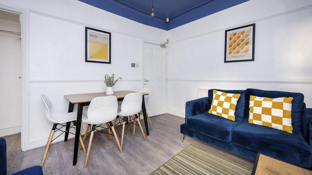 A bright and inviting large modern living room,...