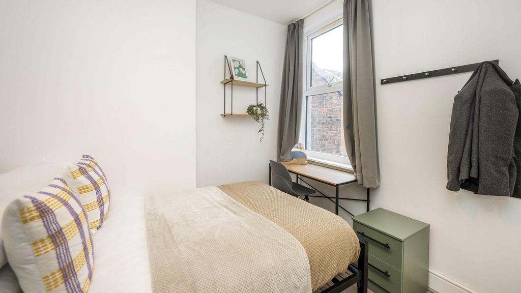 A bright and inviting double bedroom featuring ...