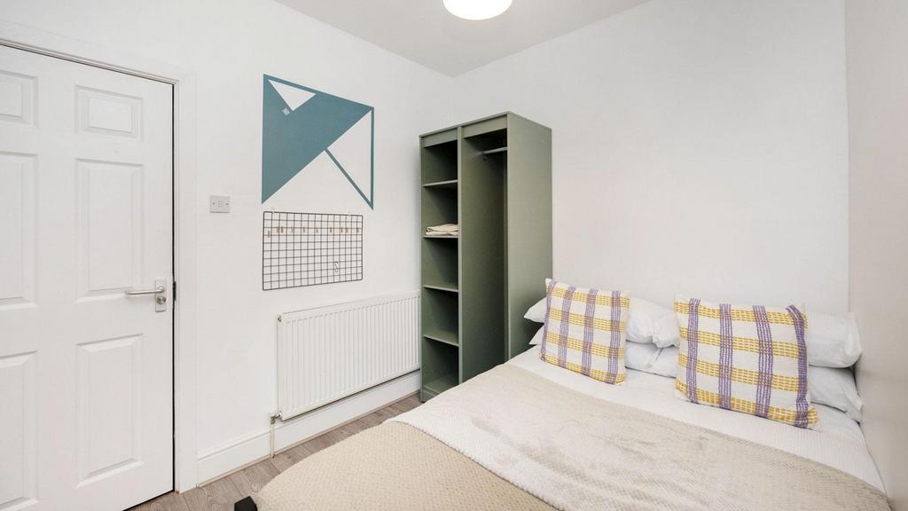 A cozy and well-decorated double bedroom, perfe...
