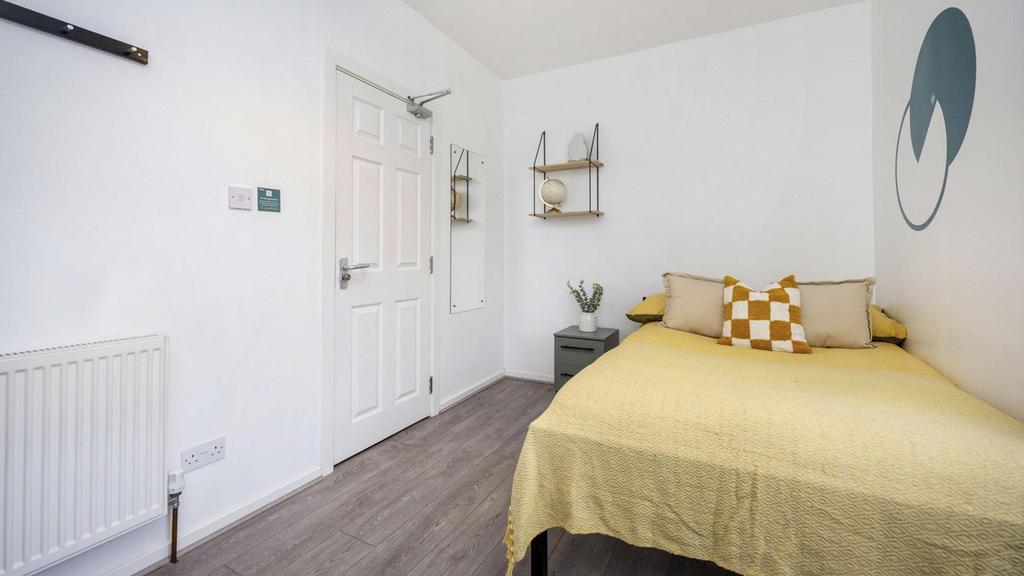 A bright and inviting double bedroom featuring ...