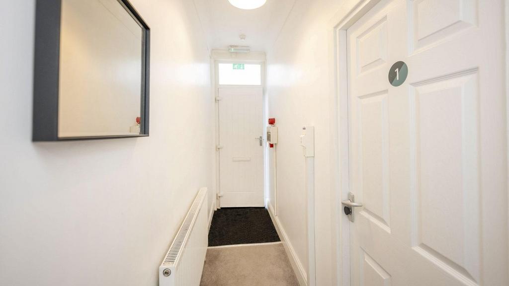 A bright and well-maintained hallway that welco...