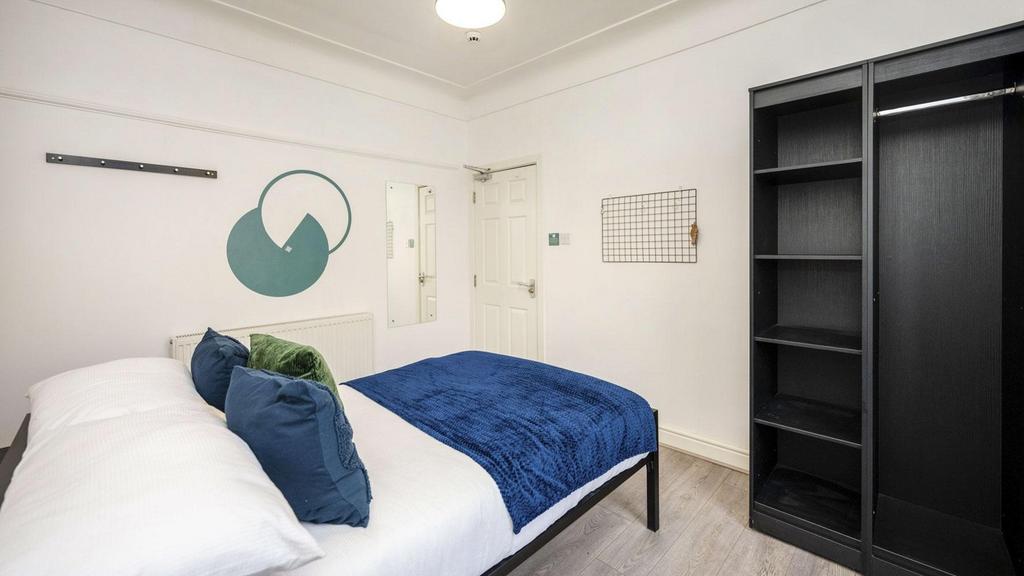 A spacious and stylish double bedroom featuring...