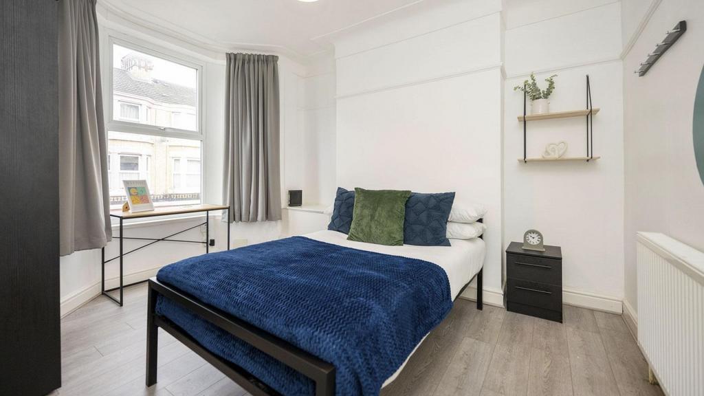 A bright and inviting double bedroom featuring ...