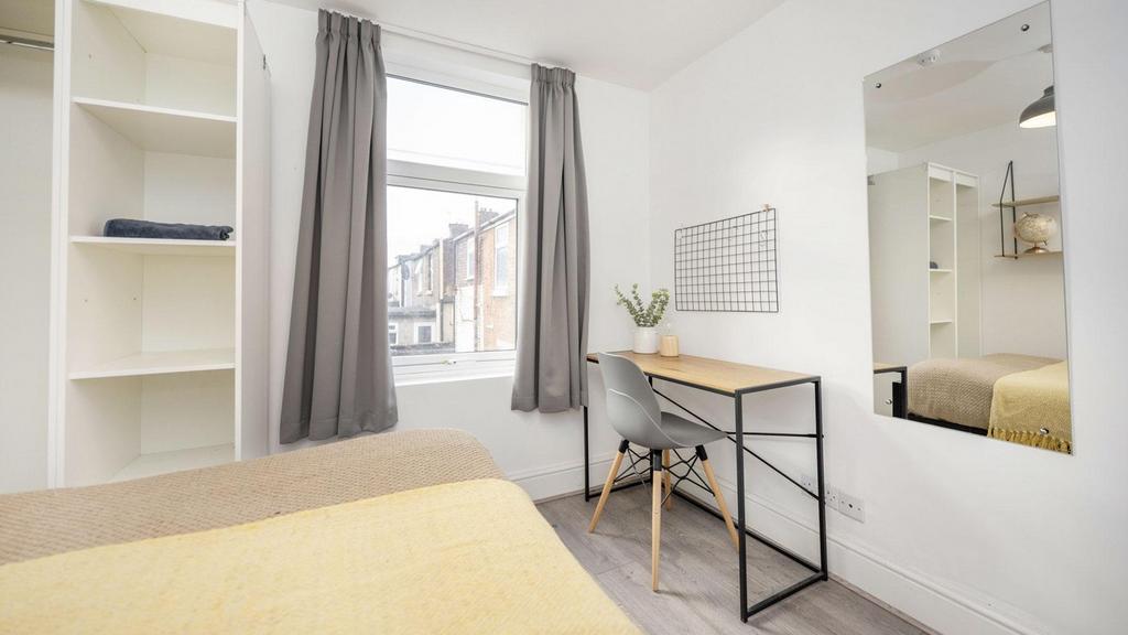 A bright and inviting double bedroom featuring ...