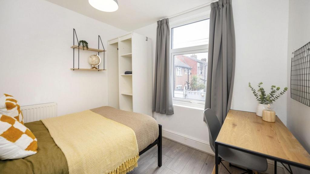 A bright and stylish double bedroom, featuring ...