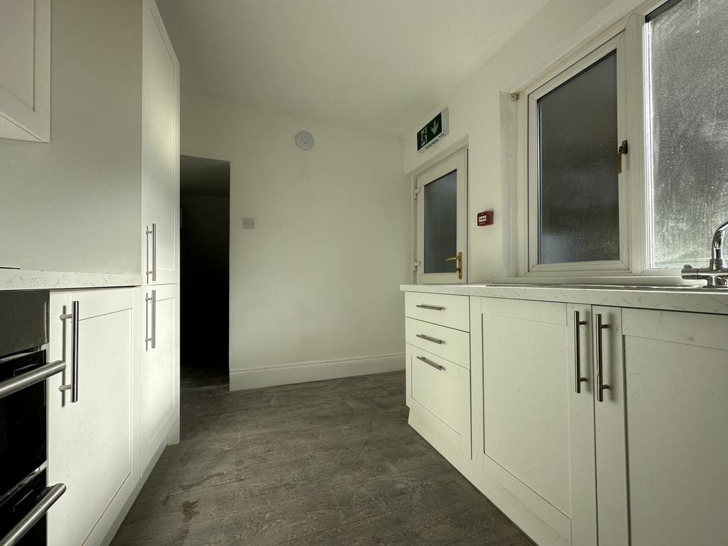 A modern kitchenette with ample storage and nat...