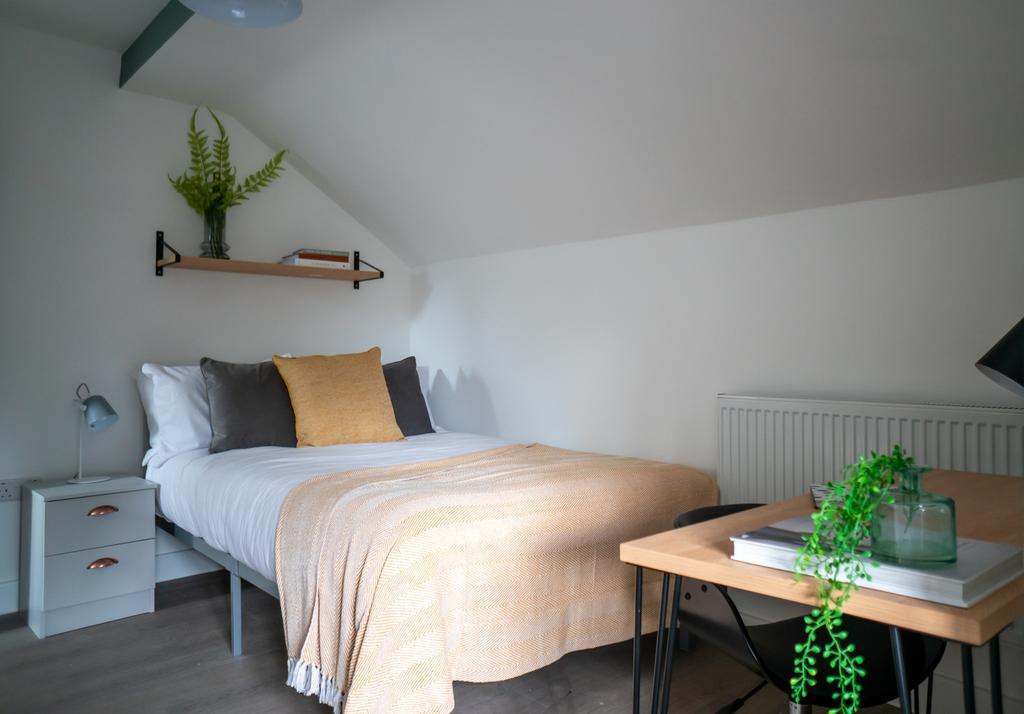 A cozy and inviting double bedroom featuring st...
