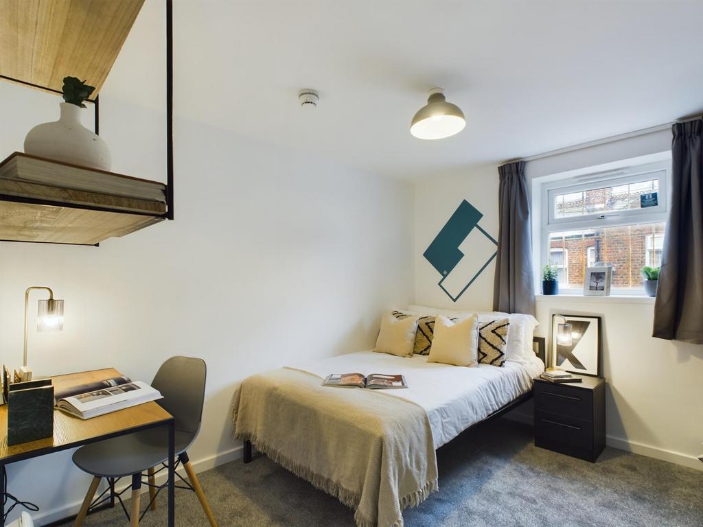 A bright and inviting double bedroom featuring ...