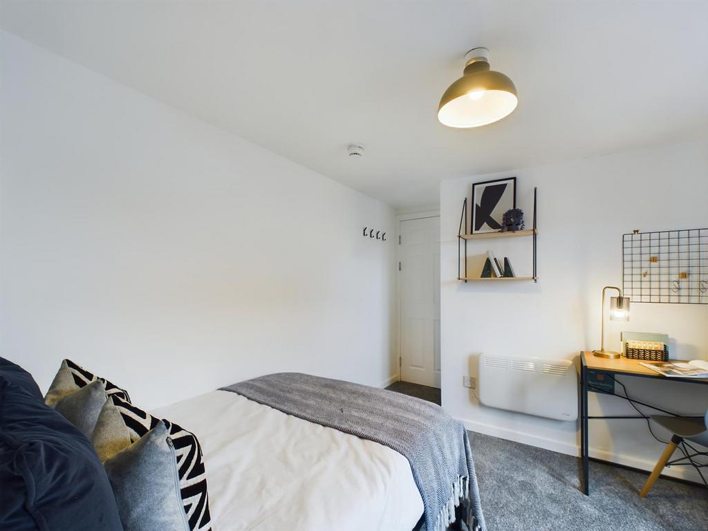 A bright and stylish double bedroom featuring a...