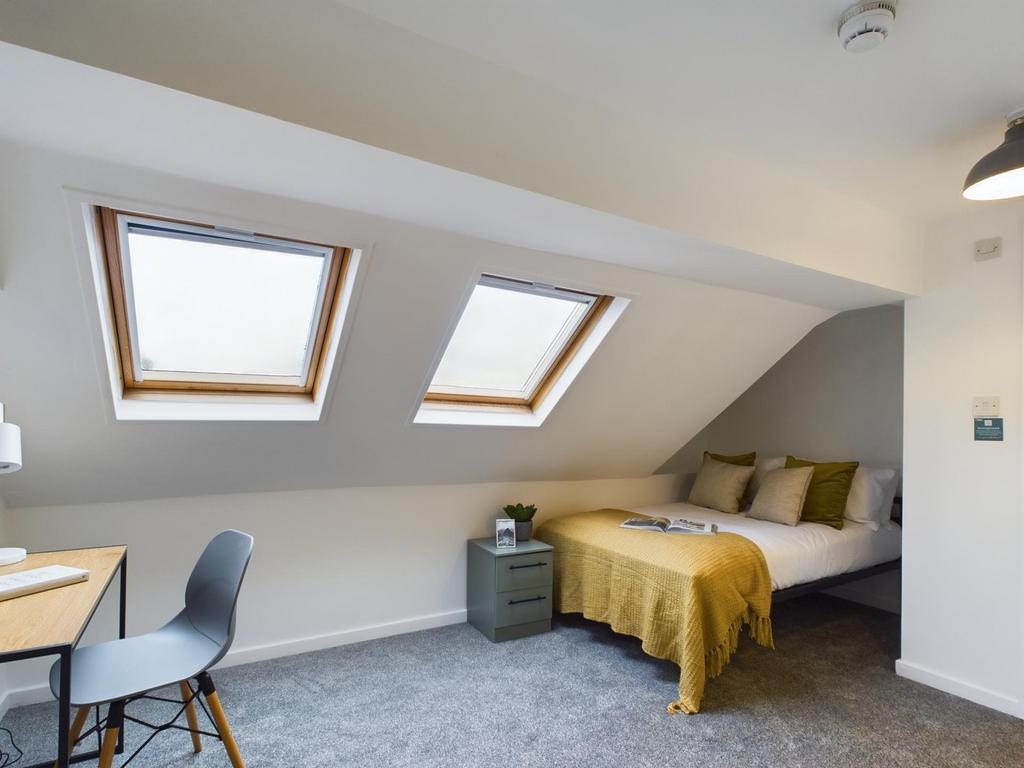 A bright and inviting double bedroom with moder...