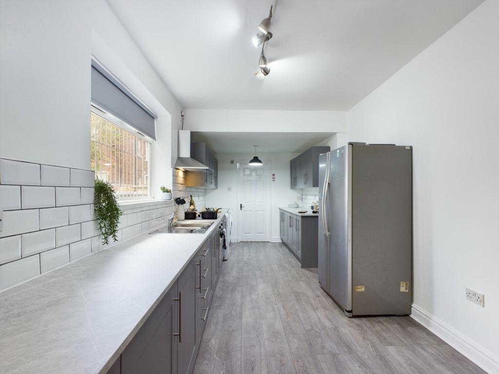 A spacious and modern kitchen with ample natura...