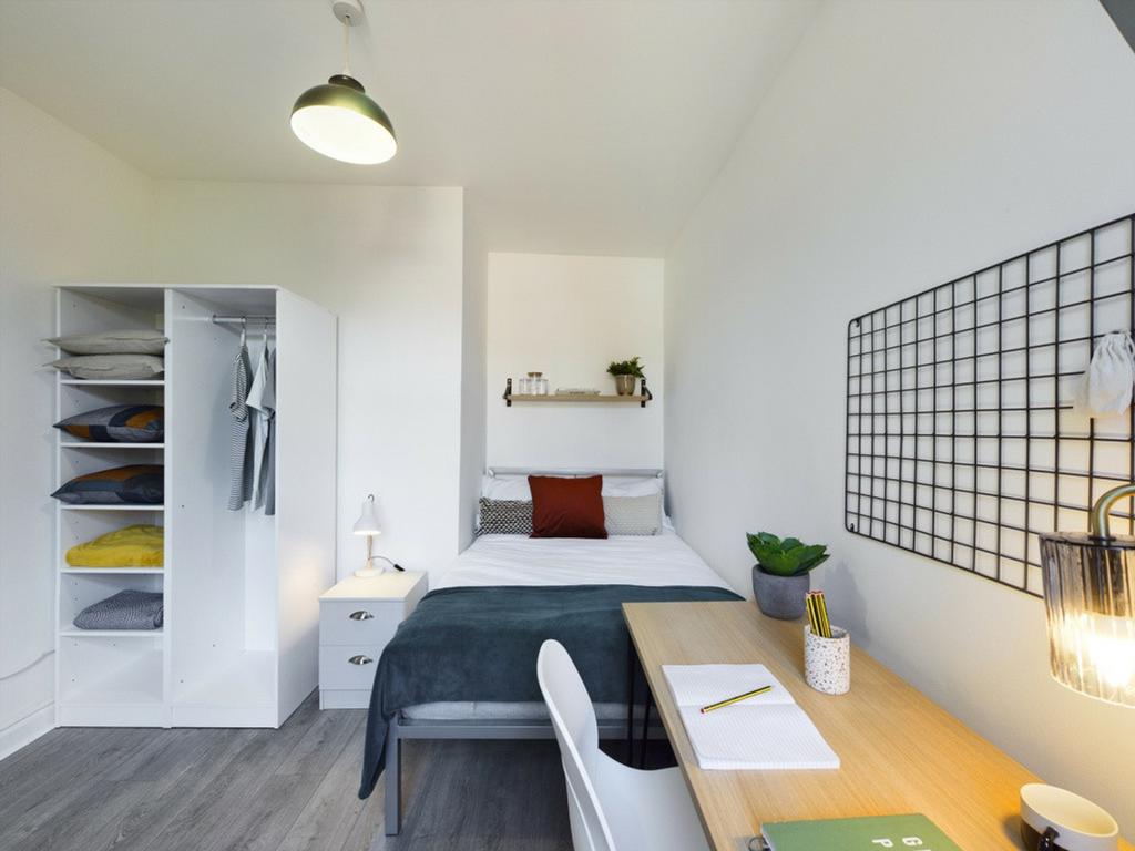 A bright and inviting double bedroom featuring ...