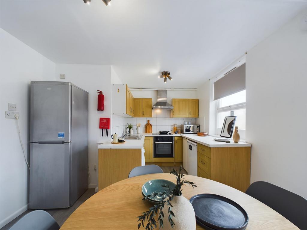 Bright, modern kitchen with light wood cabinets...