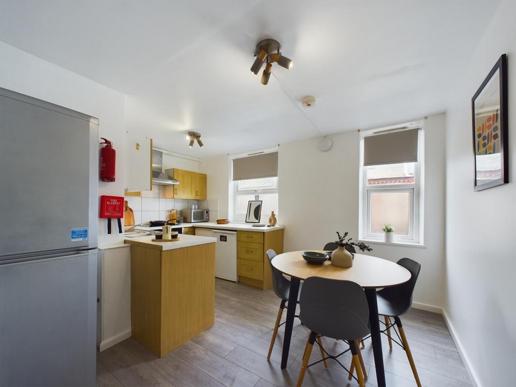 Bright, modern kitchen with integrated storage,...
