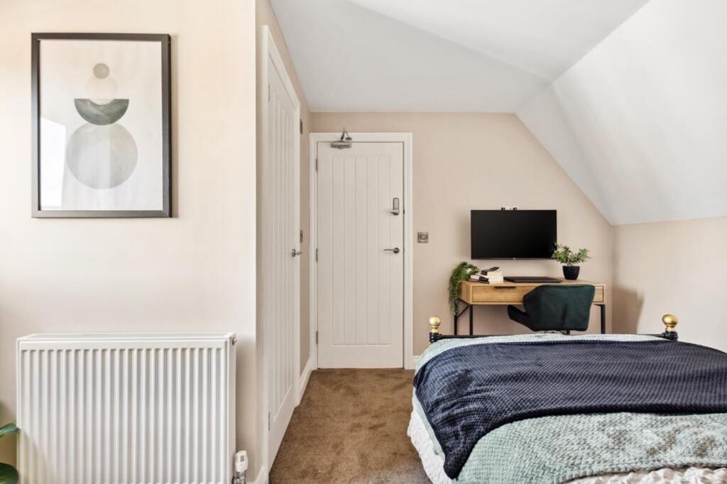 This charming double bedroom features a cozy at...