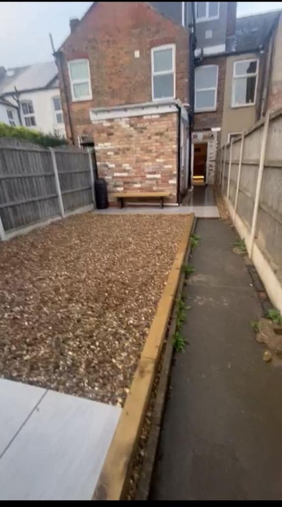 This charming garden space features a well-main...