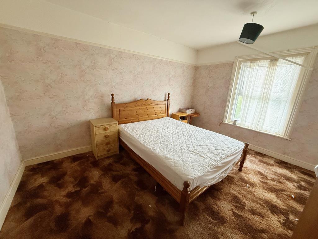 Bedroom 1 with window to the rear