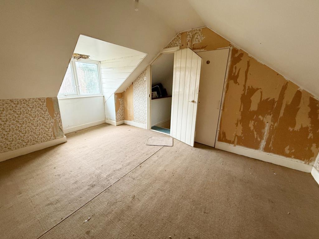 Attic Bedroom with window to the rear