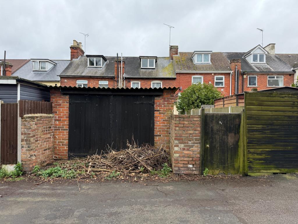 Garage in need of repair accessed from the rear