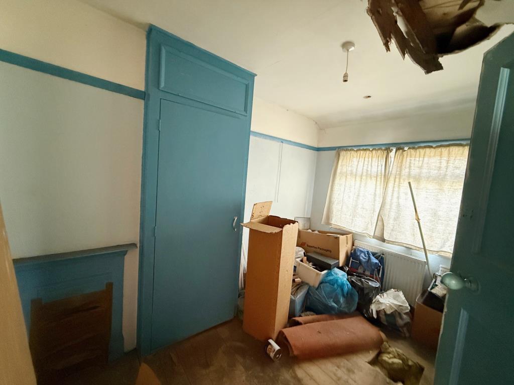Bedroom 2 with fireplace and window to the rear