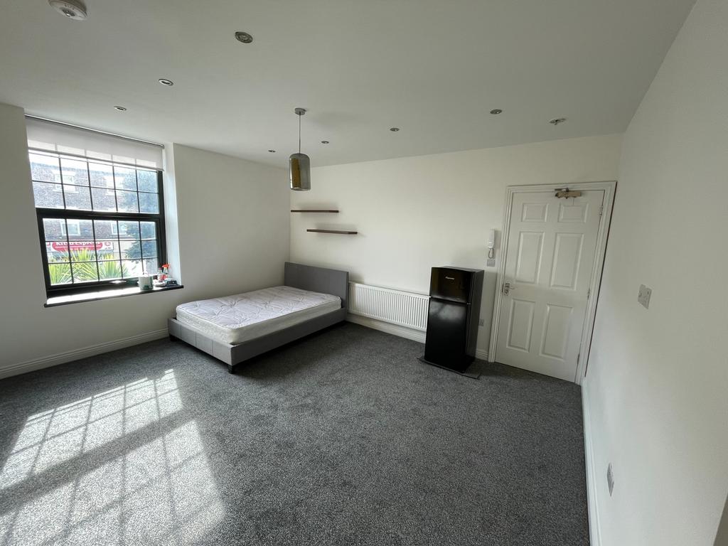 Spacious double bedroom featuring large windows...
