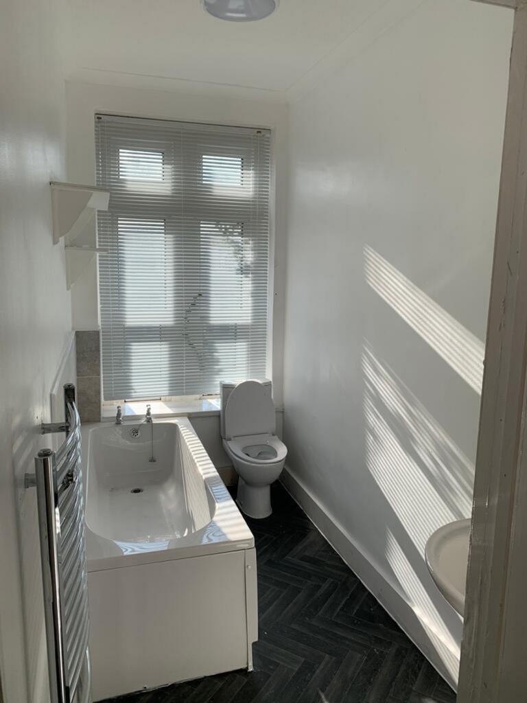 Bright and modern bathroom featuring a stylish ...