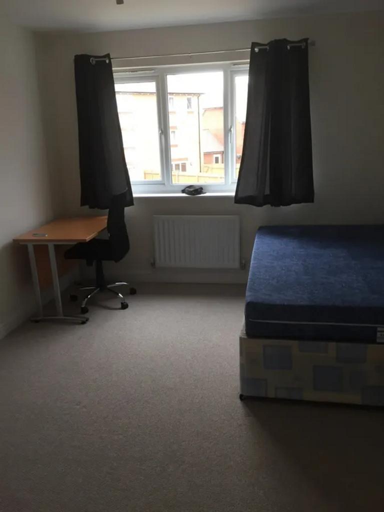 This inviting double bedroom features a comfort...