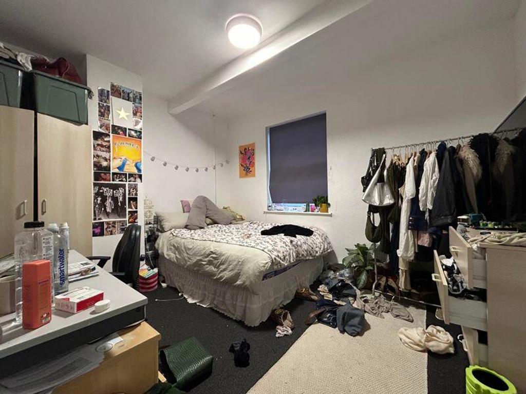 A cozy double bedroom with personal touches and...